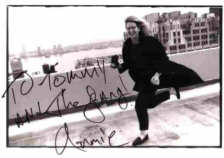Annie Leibovitz on location, black-and-white photo hand signed "To Tommy and the Gang! Annie"